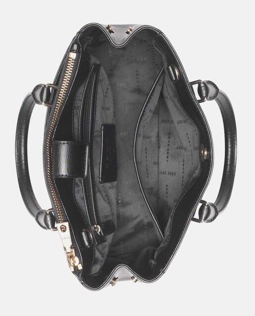 Bolso de mano DKNY de piel vacuna en negro con automáticos laterales · DKNY  · El Corte Inglés